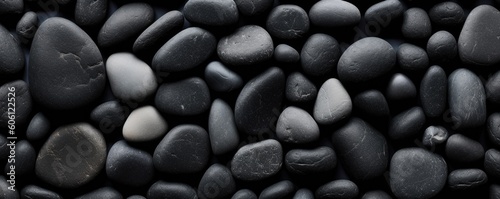 a birds-eye view of Black river stones in a  horizontal format for a product backdrop  Abtract-themed   photorealistic illustrations in JPG. Generative AI