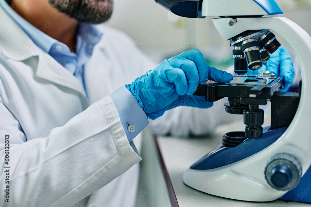 Close up of lab technician preparing medical sample for research under microscope. Close up of lab technician preparing medical sample for research under microscope.