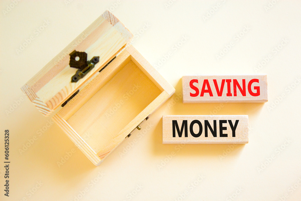 Saving money symbol. Concept words Saving money on wooden blocks on a beautiful white table white background. Empty wooden chest. Business, support and saving money concept. Copy space. Saving money symbol. Concept words Saving money on wooden blocks on a beautiful white table white background. Empty wooden chest. Business, support and saving money concept. Copy space.
