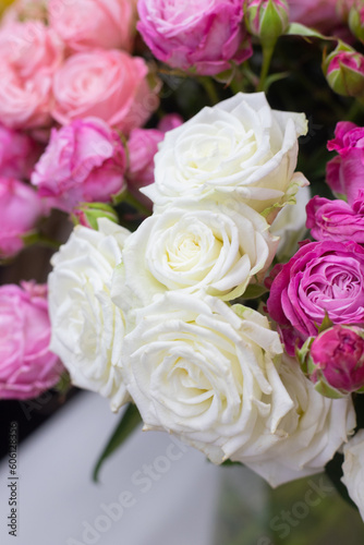 White roses close up. Showcase in a flower shop. Fresh bouquet. Master classes and floristry courses. Flower delivery.