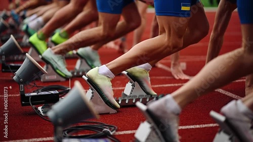 Low start of runners at the competition. Close-up