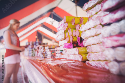 Fireworks: Woman Looking Through Variety Of Roman Candle Fireworks
