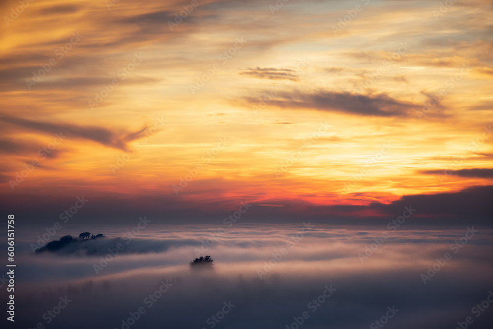 Sunset over a see of fog in winter in Euganean Hills in Italy