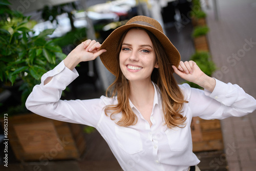Young happy woman in summer clothes,straw hat posing on nature background,making selfie portrait.Summer portrait © GRON777