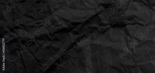 Black crumpled paper as background or texture.