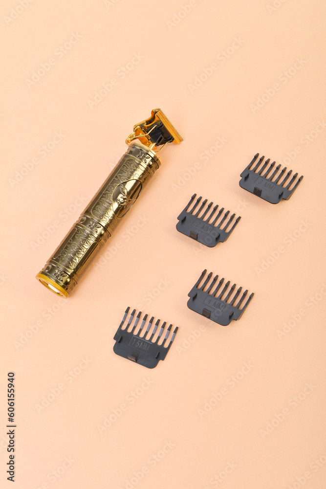 Fototapeta premium Electric hair trimmer on pink background.