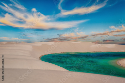 White Sand Dunes Among Lakes with Blue Water and Some Clouds in the Sky, Barreirinhas, Lencois Maranhenses National Park in Maranhão, Brazil photo