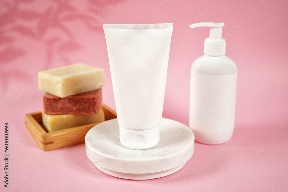 Cosmetic skincare blank container mockups in a styled setting. Pink background with leaves shadow photography. Cosmetic skincare blank container mockups in a styled setting. Pink background with leaves shadow photography.