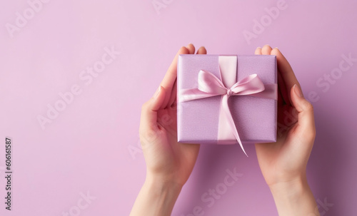 Woman's hands holding gift or present box on pink pastel background, top view. Generative AI © tania_wild