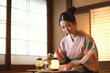 Japanese woman wearing kimono preparing tea at traditional tea ceremony