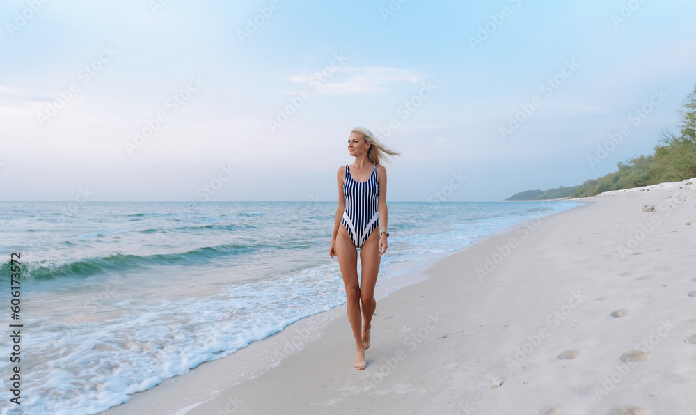 girl in a swimsuit at the sea at dawn