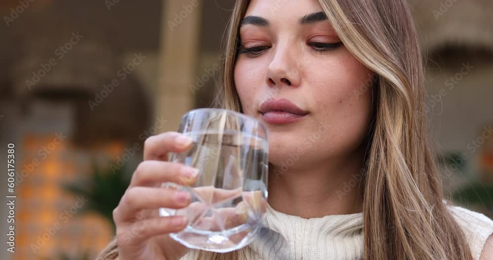 woman drinking water at cafe woman drinking water at cafe