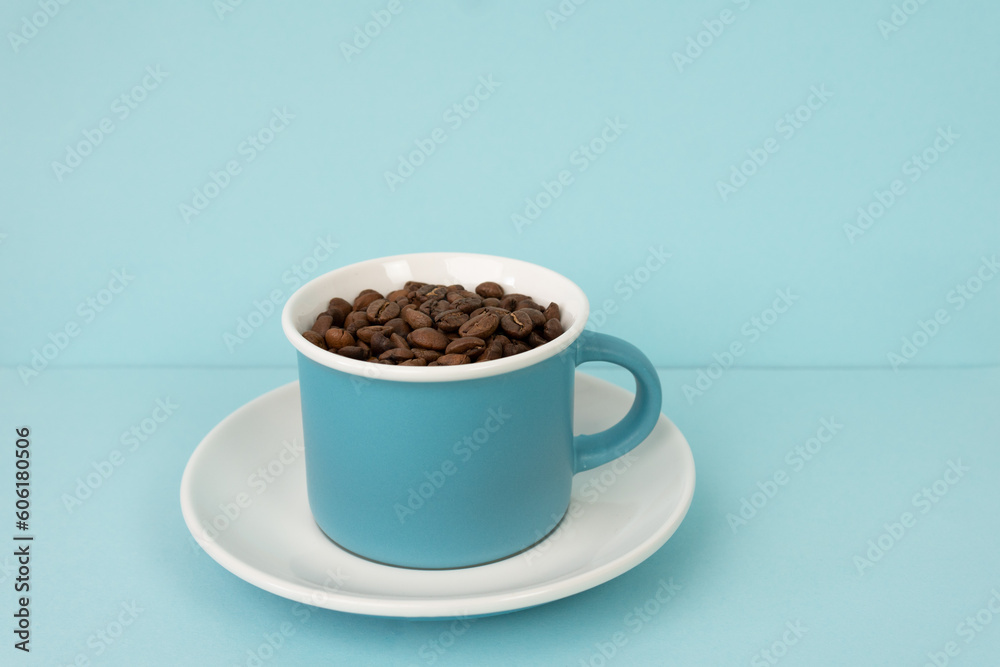 Coffee beans in blue cup on blue background Coffee beans in blue cup on blue background