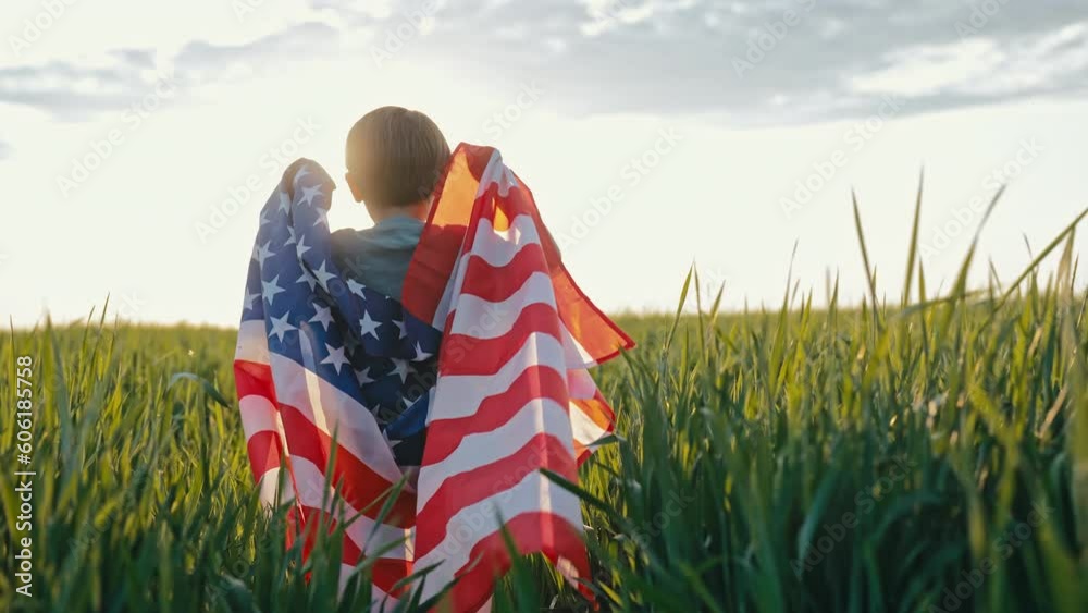 Cute little boy - American patriot kid running with national flag in green field. USA, 4th of July - Independence day, celebration. US banner, memorial Veterans, election, America, labor