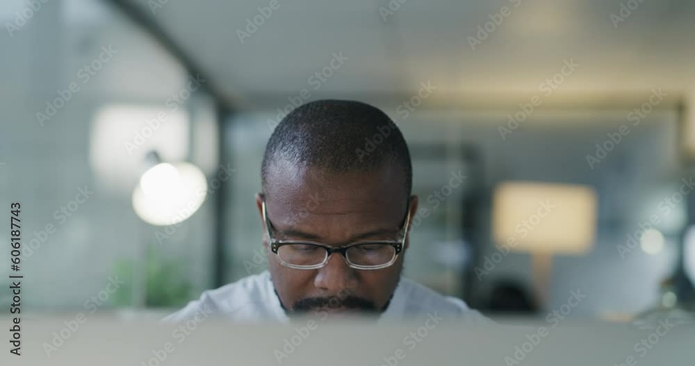 Computer, african and a mature business man at work in his office late at night on a management project. Face, glasses and a professional male manager or CEO working online for a company report Computer, african and a mature business man at work in his office late at night on a management project. Face, glasses and a professional male manager or CEO working online for a company report