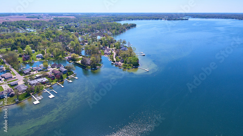 Obraz na plátně Lake houses on distant shore aerial asset water property green algae in water pi