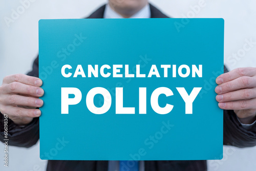 Businessman holding turquoise banner with inscription: CANCELLATION POLICY. Concept of business cancellation policy. Agreement Of Cancellation Policy. photo