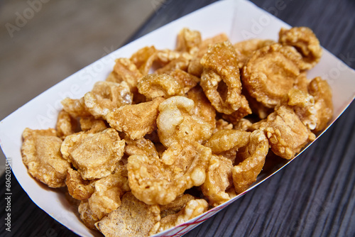 Pork Rinds chicharrones white tray red stripes slate gray textured blurred background food