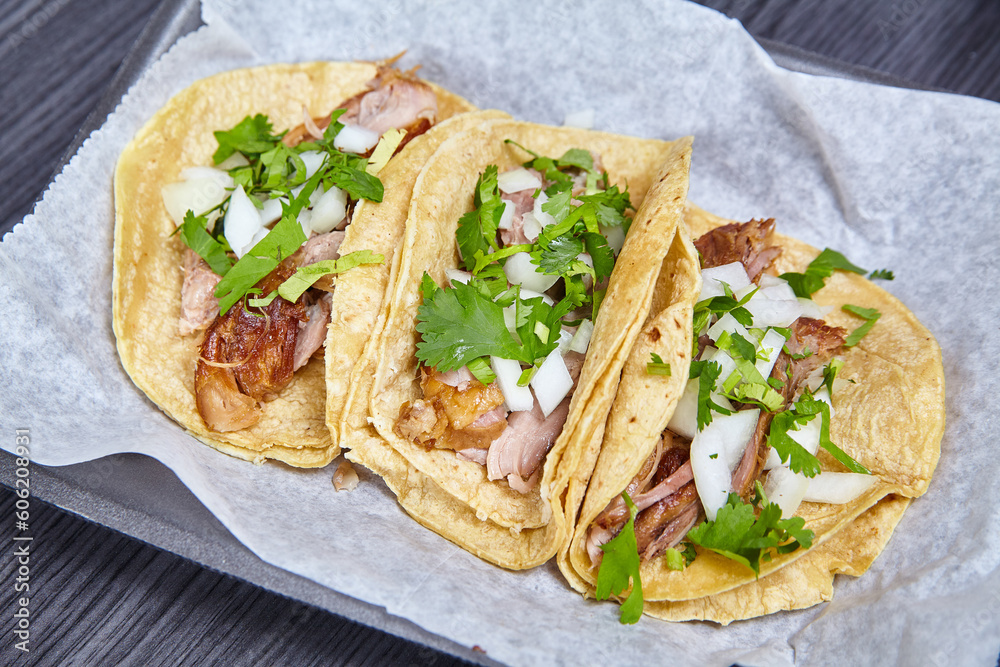 3 Carne Asada street tacos Mexican white onion cilantro corn tortillas white paper black tray 3 Carne Asada street tacos Mexican white onion cilantro corn tortillas white paper black tray