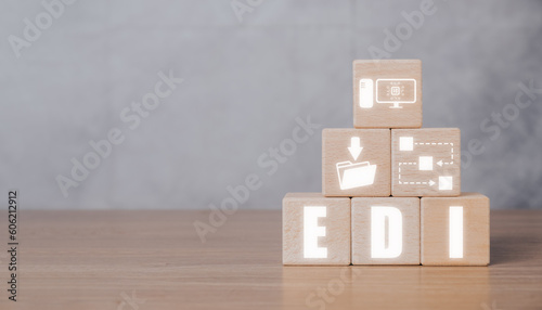 EDI, Electronic data interchange concept, Wooden block on desk with Electronic data interchange icon on virtual screen.
