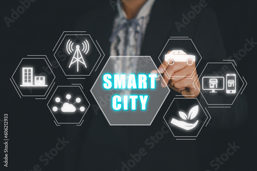 Smart city concept, Person hand touching smart city icon on virtual screen.