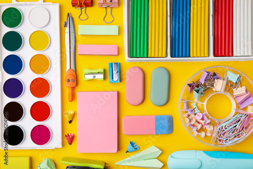 Many different school stationery on yellow background, flat lay. Back to school
