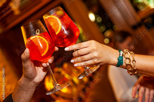 couple cheering Apperol spritz drink close up