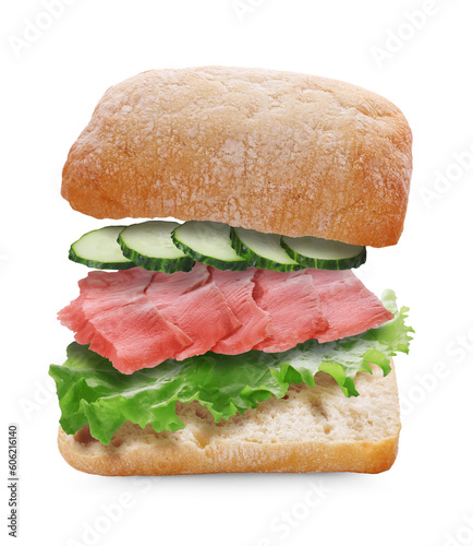 Tasty ciabatta sandwich with fresh ingredients in air on white background
