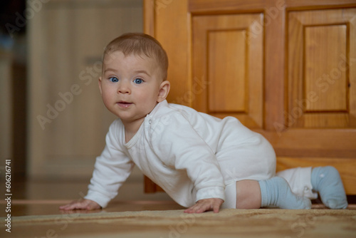 Portrait of a crawling child on the carpet in my room © Евгений Бордовский
