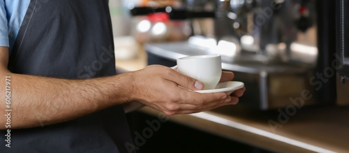 Barista with cup of hot coffee in cafe. Banner for design © Pixel-Shot