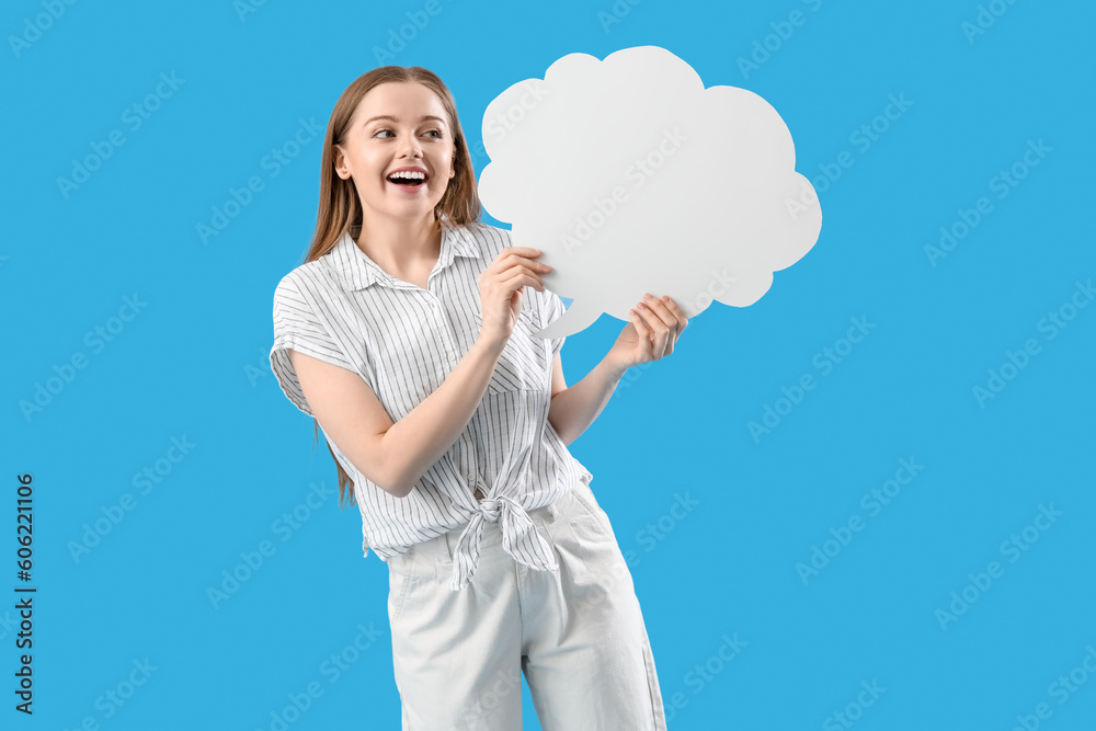 Happy young woman with blank speech bubble on blue background Happy young woman with blank speech bubble on blue background