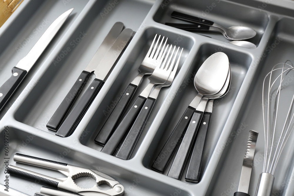 Open kitchen drawer with different silver cutlery Open kitchen drawer with different silver cutlery