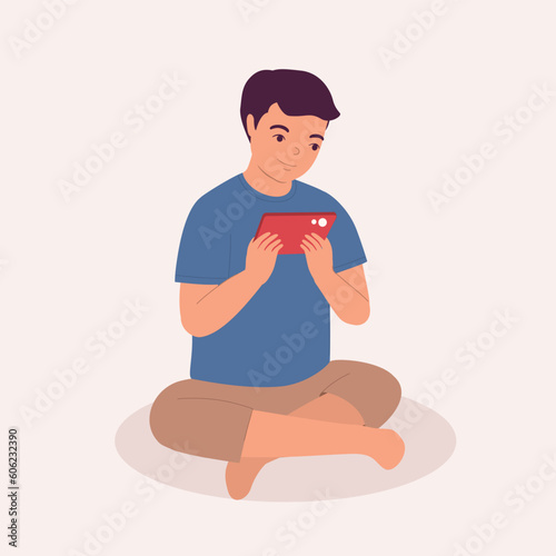 One Smiling Little Boy Playing Video Game With His Mobile Phone While Sitting On Floor. Digital Native. Full Length. Flat Design Style, Character, Cartoon.