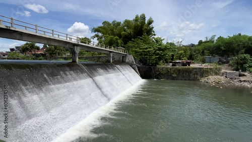 Water dam with strong current under the bridge photo