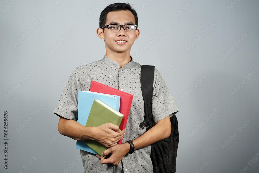 Student asian man with glasses, black backpack and carrying book. Student asian man with glasses, black backpack and carrying book.