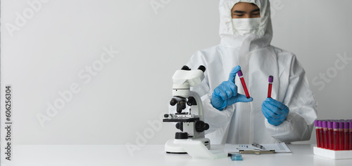 copy space, banner, panorama Technician, doctor, laboratory scientist with blood sampling tube in lab holding blood sample for study, experiment, medical research biotechnology DNA testing.