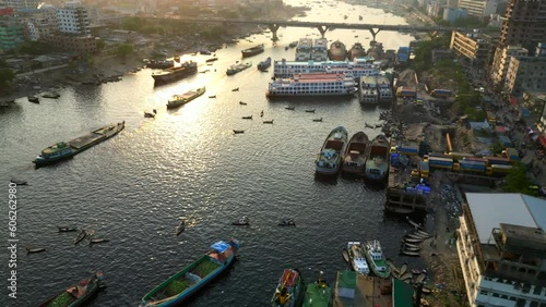 Birds eye view drone shot boats and ships docked on Buriganga River photo