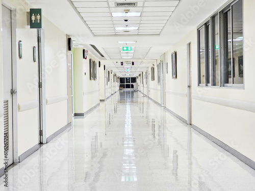 Long hospital bright corridor with rooms. Empty modern hospital corridor.