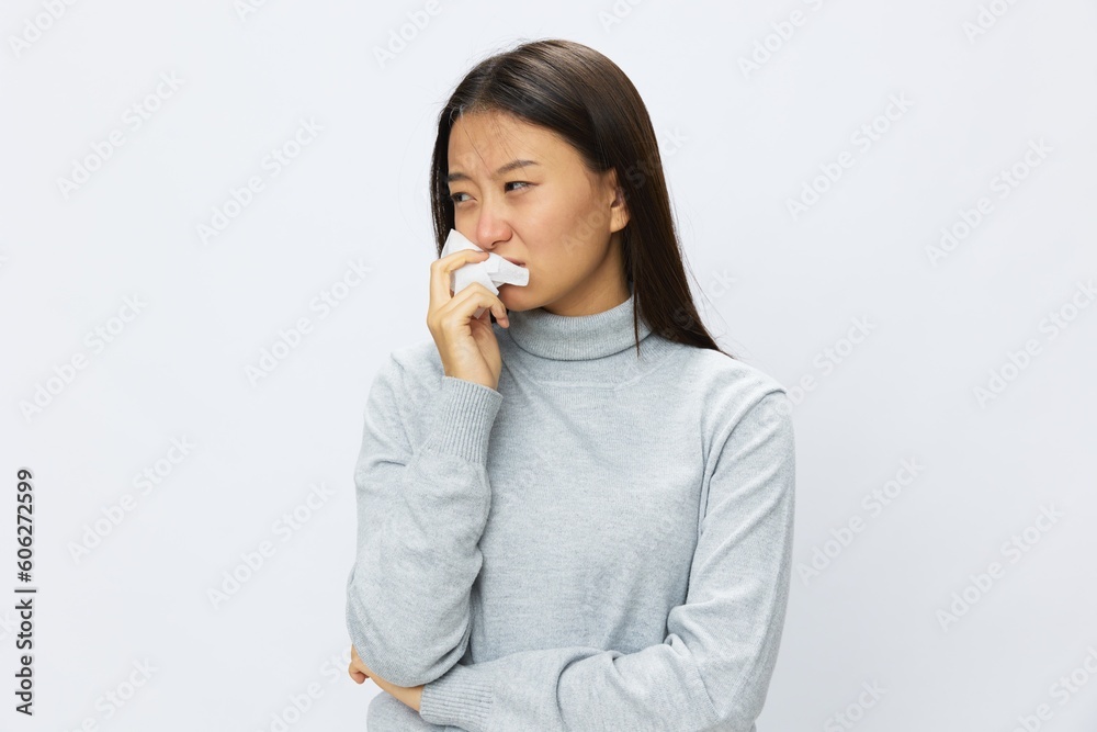 Asian woman holding hand with handkerchief and coughing up flu and cold, stuffy nose viral disease asthma and allergies covid, white background Asian woman holding hand with handkerchief and coughing up flu and cold, stuffy nose viral disease asthma and allergies covid, white background