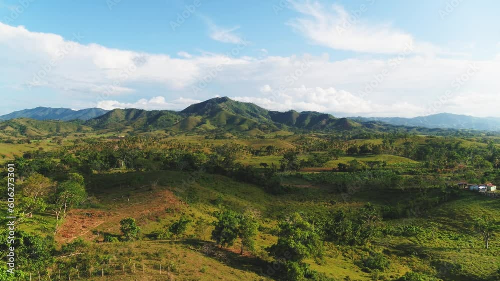 View of a sunny mountain valley with a beautiful panoramic landscape. Green hills against a blue cloudy sky. Vibrant landscape of Dominican wildlife. Summer travel. Serene scenic view. View of a sunny mountain valley with a beautiful panoramic landscape. Green hills against a blue cloudy sky. Vibrant landscape of Dominican wildlife. Summer travel. Serene scenic view.
