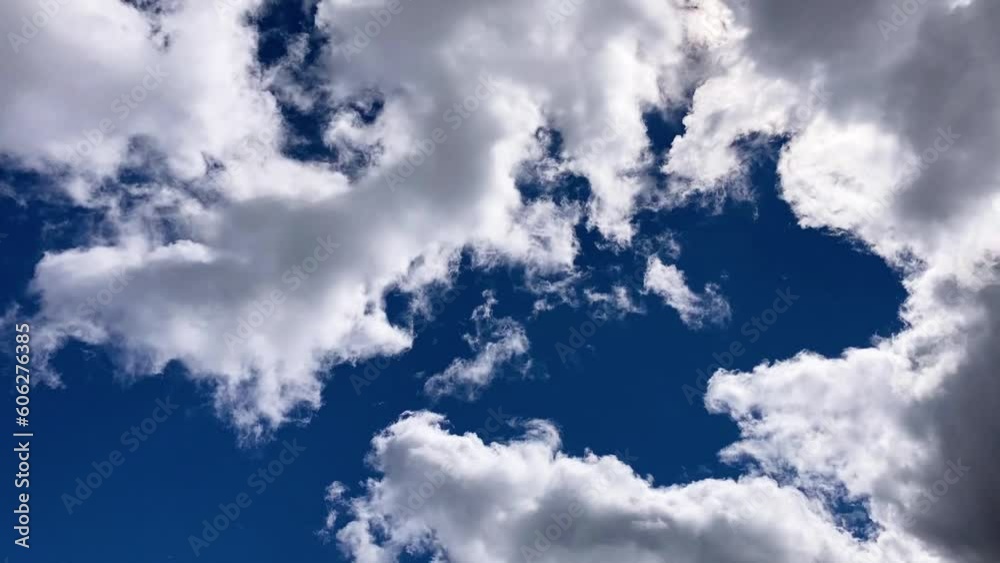 Timelapse of clouds passing across a blue sky on a sunny day Timelapse of clouds passing across a blue sky on a sunny day
