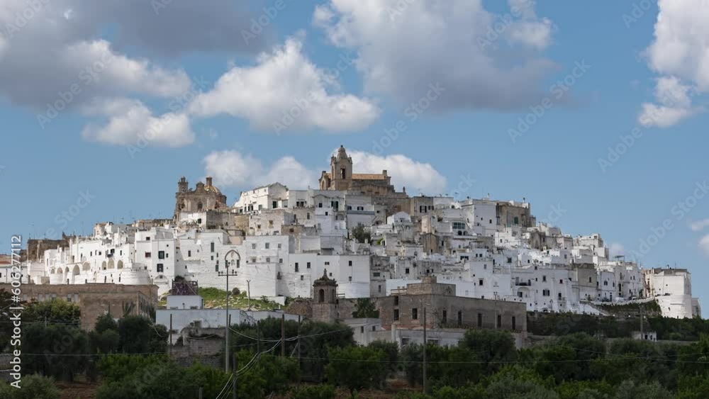 Time lapse of white old city Ostuni in Puglia, Italy, on sunny day with cumulus clouds Time lapse of white old city Ostuni in Puglia, Italy, on sunny day with cumulus clouds