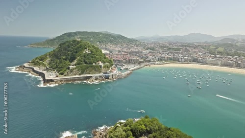 Panoramic aerial of La Concha bay and boats entering near Mount Urgull walls photo