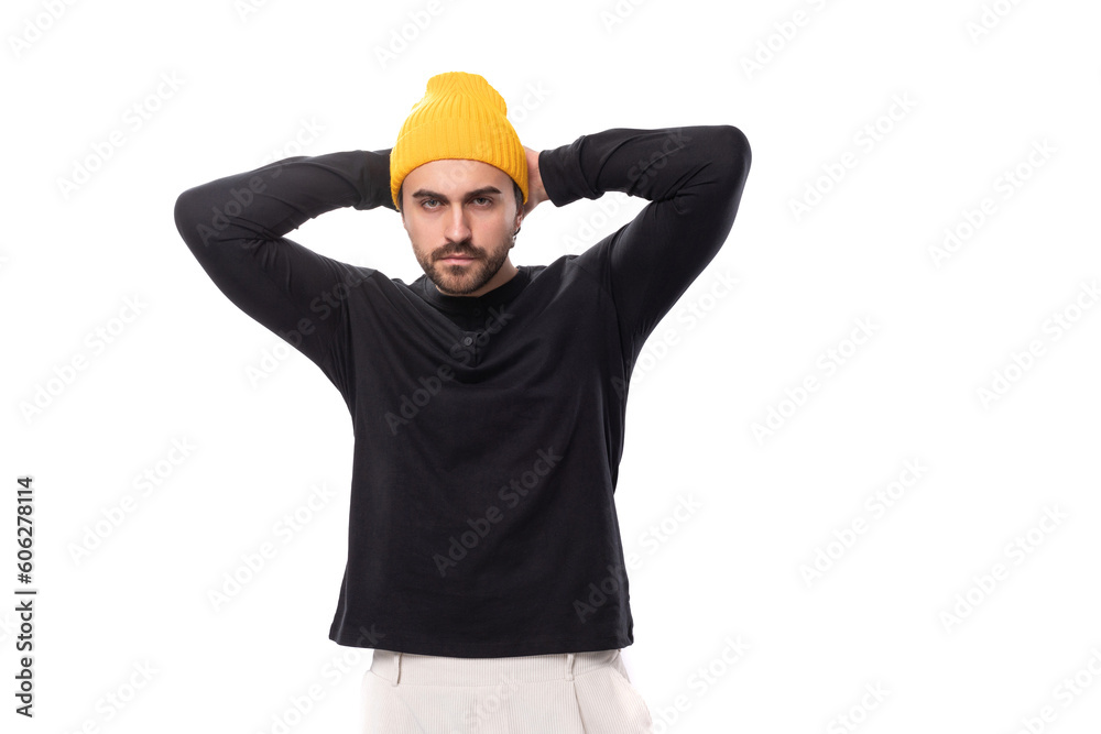 young well-groomed stylish brunette European brutal man in a black sweatshirt on a white background with copy space