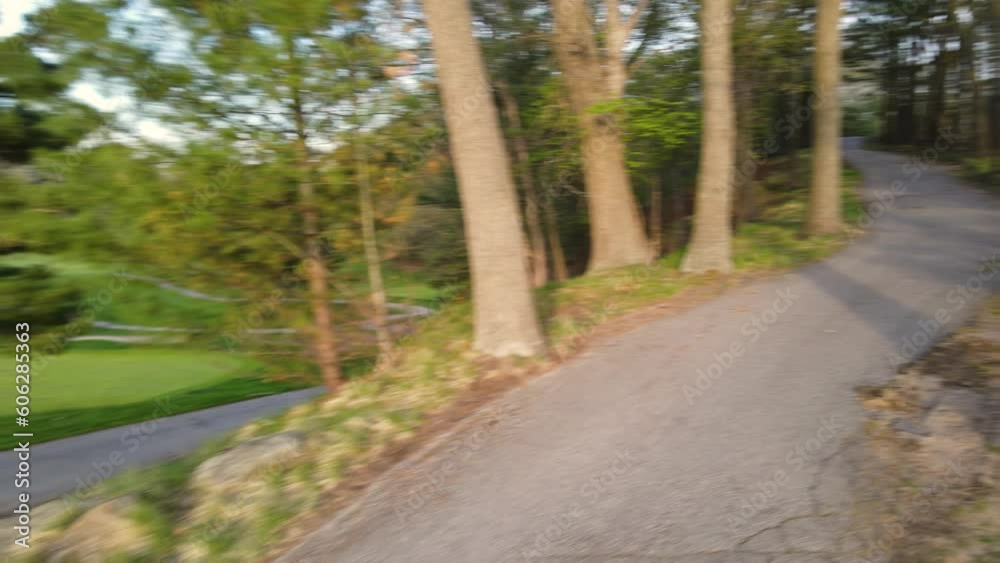 Drone pulling back and turning away from a Golf Cart Path. Drone pulling back and turning away from a Golf Cart Path.