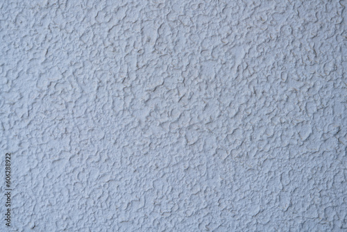 The uneven plastered walls are painted soft white for the background.