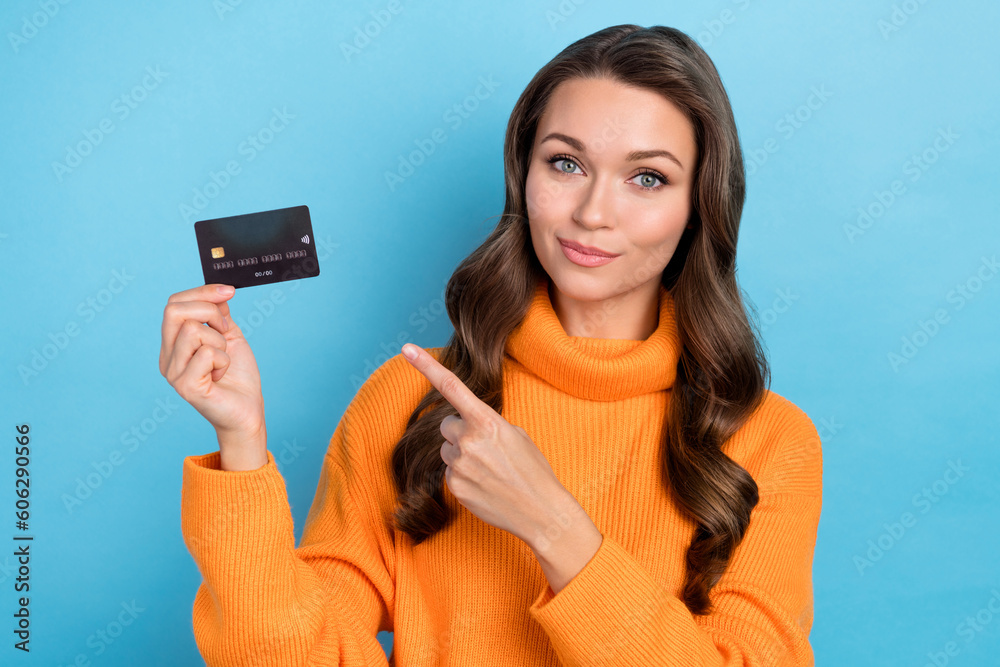 Photo of curly haired lady demonstrate credit card pointing using for consumerism commerce isolated blue color background Photo of curly haired lady demonstrate credit card pointing using for consumerism commerce isolated blue color background