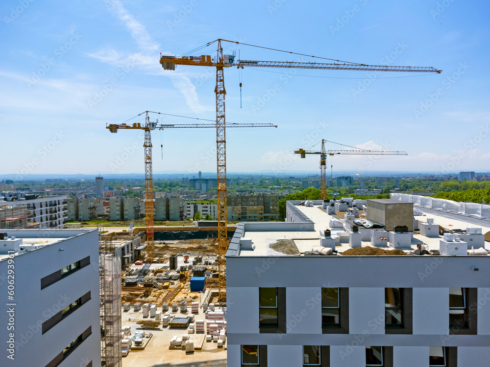 Aerial view landscape. Drone view of modern housing estate, apartment blocks, under construction, cranes, renovation.