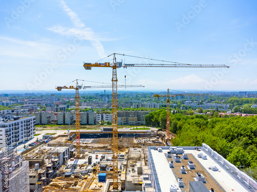 Aerial view landscape. Drone view of modern housing estate, apartment blocks, under construction, cranes, renovation. © karolinaklink