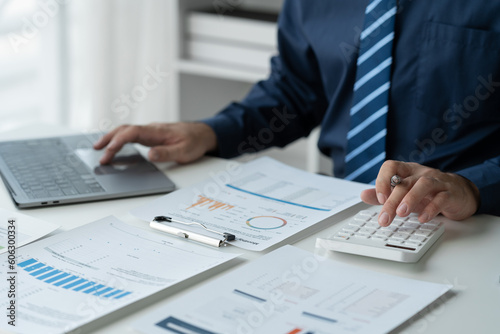 business people working on laptops Analyze business documents with graphs. financial chart Calculate market performance report on digital tablet business data analysis concept.